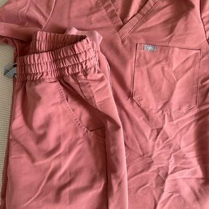 Small rose colored fig scrubs gently worn